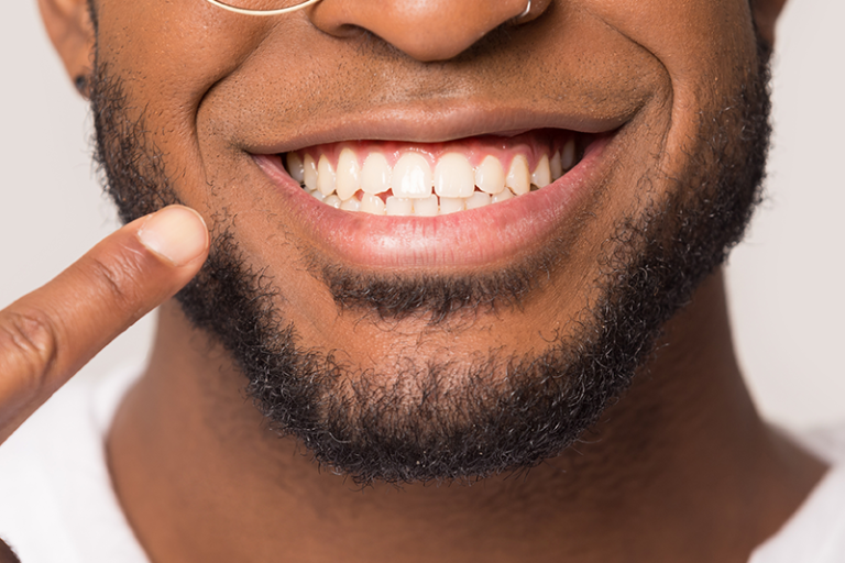 Experienced family dentist performing routine dental exam