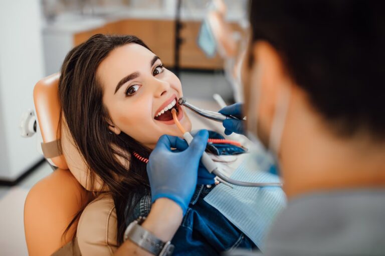 Dentist applying fluoride treatment to a child’s teeth